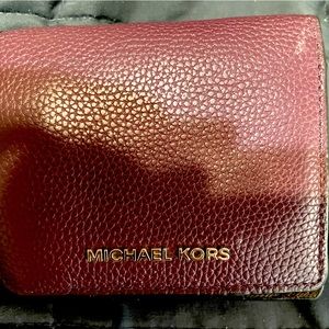 Michael Kors burgundy folding wallet.